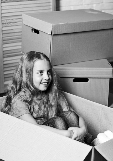 Breathtaking Apartments. happy child cardboard box. happy little girl with bear toy. purchase of new habitation. repair of room. new apartment. Cardboard boxes - moving to new house - 写真・画像