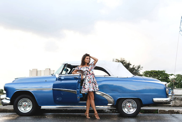 Young, beautiful and happy woman driving a retro convertible car - Foto, Imagen