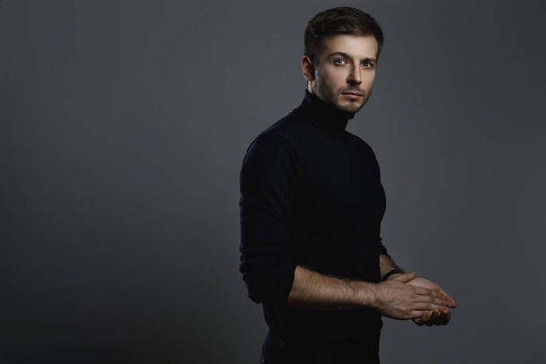 Portrait of young handsome man wearing a polo neck - Foto, Imagen
