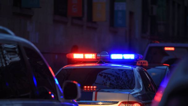 Police car at night with flashing lights.  - Fotografie, Obrázek