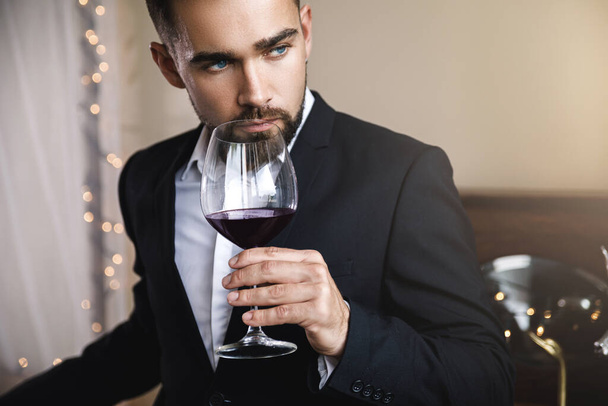 Portrait of handsome bearded man with a glass of red wine - Photo, Image
