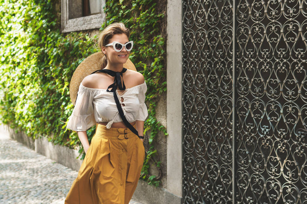 Stylish young woman walkin by the streets of small Italian town - Фото, зображення