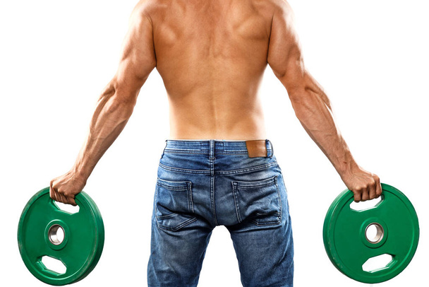 Young muscular man is posing with barbell weight plate on white background - Φωτογραφία, εικόνα
