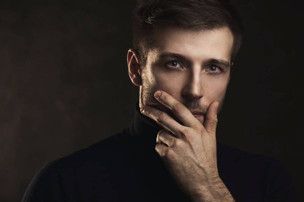 Portrait of young handsome man wearing a polo neck - Foto, immagini