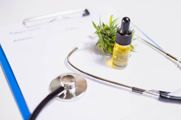 Doctor's prescription, stethoscope and hemp oil in a glass bottle, alternative medicine concept Herbal treatment and treatment. Medical marijuana research. - Photo, Image
