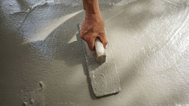 construction - plasterer concrete with worker hand - Photo, Image