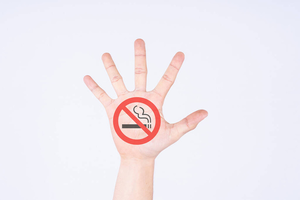 Open hand raised. No smoking sign painted. No smoking on white isolated white background. World no tobacco day concept - Photo, Image