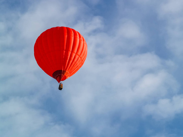 Vörös hőlégballon repül a kék égen Cappadocia felett. Légballonnal történő utazás. - Fotó, kép