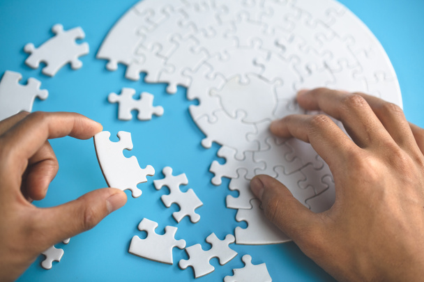 Closeup hand of woman connecting jigsaw puzzle, Business solutions, success and strategy concept - Foto, Bild