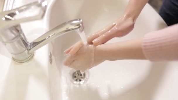 Coronavirus pandemic prevention wash hands with soap warm water rubbing fingers washing frequently or using hand sanitizer gel. - Footage, Video