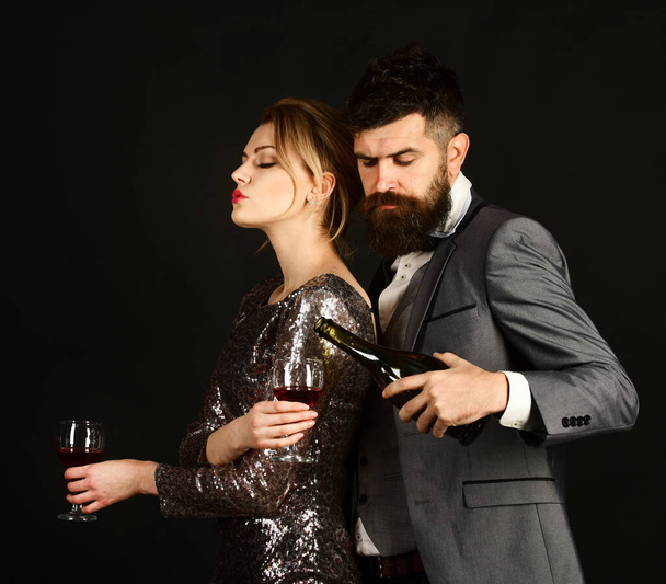 Couple in love holding glasses on black background - Photo, Image