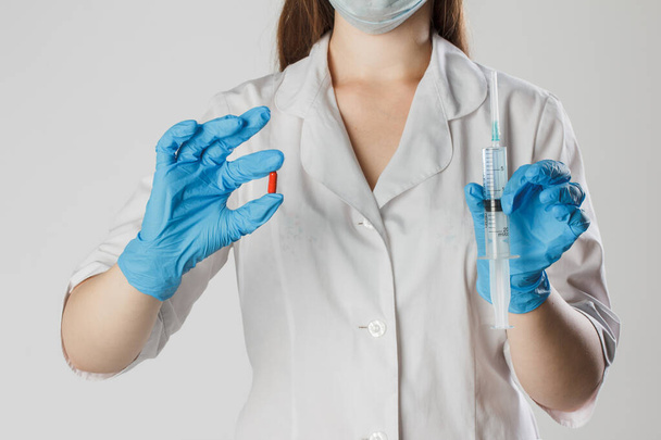 Doctor, nurse, scientist hand in blue gloves holding flu, measles, coronavirus, pandemia, epidemic, covid-19 vaccine disease preparing for human vaccination shot and pills, medicine and drug concept - Photo, image