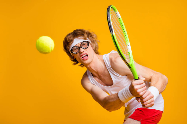 Portrait of his he nice funky muscular motivated successful guy playing court tennis spending vacation weekend professional gamer isolated over bright vivid shine vibrant yellow color background - Fotoğraf, Görsel