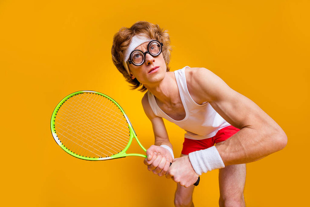 Portrait of his he nice funky muscular focused motivated guy playing tennis spending vacation free time weekend professional isolated over bright vivid shine vibrant yellow color background - Photo, image