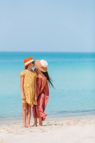 Beautiful mother and daughter on the beach - Фото, изображение