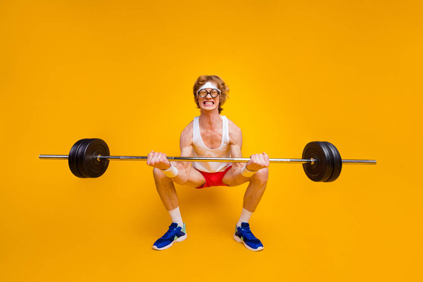 Full length body size view of nice funky motivated weak guy lifting barbell doing work out coacher trainer program regime body building isolated over bright vivid shine vibrant yellow color background - Zdjęcie, obraz