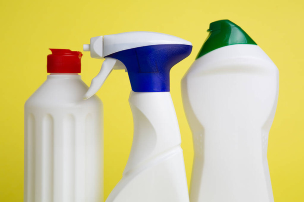 three cans of cleaning products on yellow background - Фото, зображення