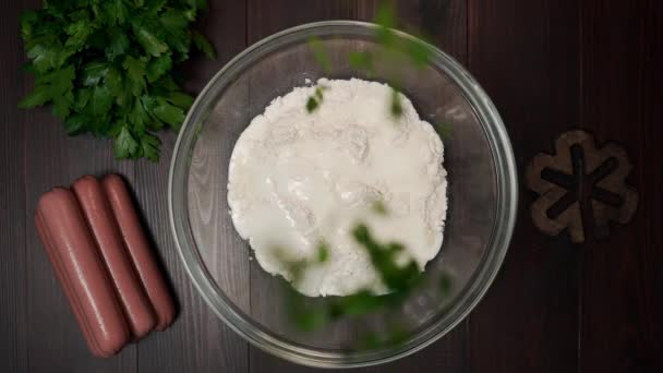 parsley falls to the bowl with dough cooking at home - Felvétel, videó