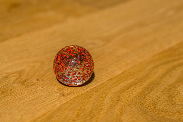 átlátszó piros golyó a fa textúra - Fotó, kép