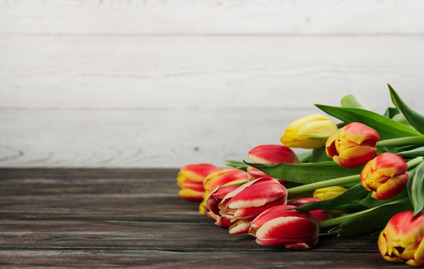 Bouquet of red, yellow and pink tulips on a white wooden background copy space - Foto, immagini