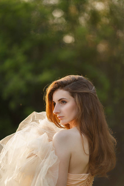 Fine Art Portrait of a beautiful bride with a veil in a summer garden - Photo, Image