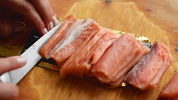 Chef in kitchen cutting red fish on cutting board - 映像、動画