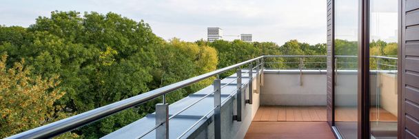 Panorama of elegant building with stylish balcony and amazing view on green trees - Foto, Imagen