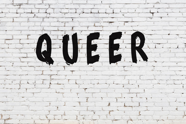 Word queer painted on white brick wall - Photo, Image