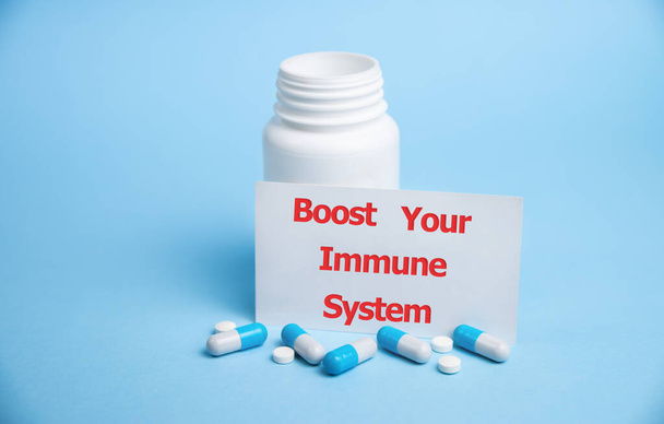 boost your immune system - inspirational handwriting on white card with medical pills - Foto, immagini