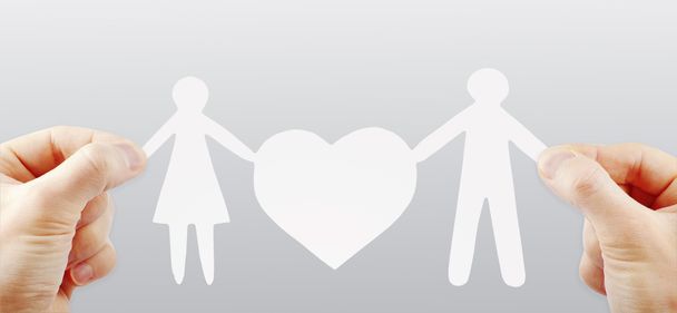 paper family with heart in hands - Foto, Imagem