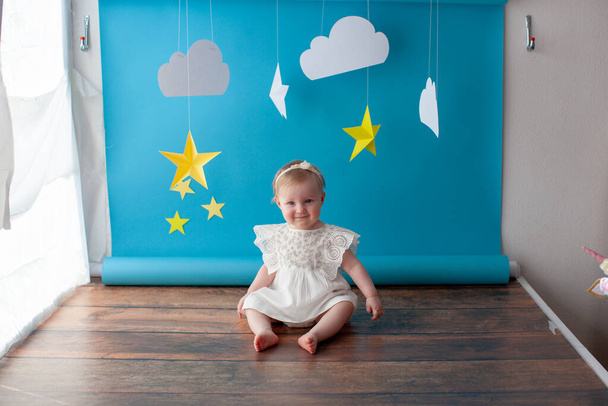 First baby birthday. Girl touches a star. - Фото, изображение