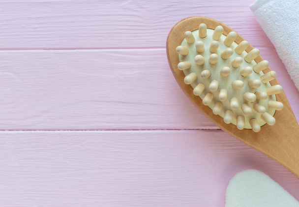 Close up wooden massage brushes for skin and body care on pink background. Beauty, spa and bath concept.  Flat lay, top view - Valokuva, kuva
