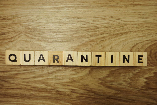 Quarantine alphabet letter on wooden background - Foto, Imagem