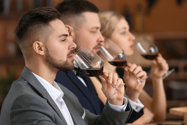 Οι άνθρωποι δοκιμάζουν κρασί στο εστιατόριο - Φωτογραφία, εικόνα