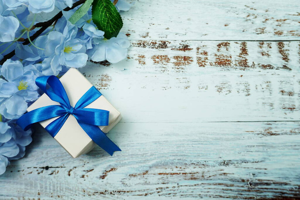 Blue Gift Box and flower decoration on wooden background - Fotoğraf, Görsel