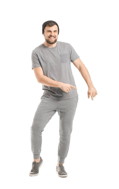 Handsome young man dancing against white background - Foto, Imagen