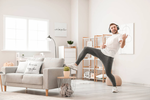 Handsome man dancing and listening to music at home - Fotoğraf, Görsel