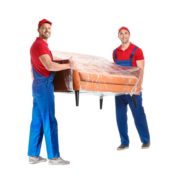 Loaders carrying furniture against white background - Photo, Image