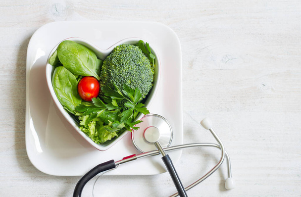 Healthy green diet in the heart concept with stethoscope - Fotoğraf, Görsel