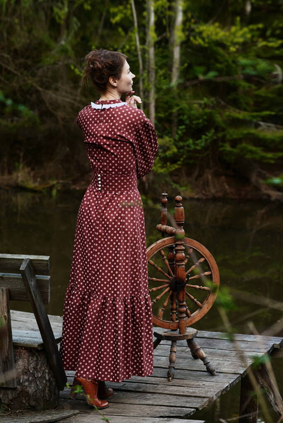 Pretty girl in long dress at the deep forest - Foto, afbeelding