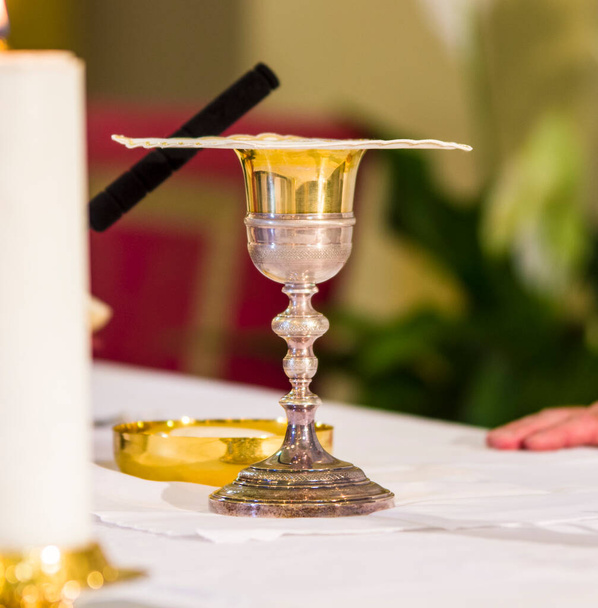 chalice for wine, blood of christ, and ciborium with host, body of christ, and ampoules with wine and water for the consecration on the others of the churches for pope francesco - Photo, Image