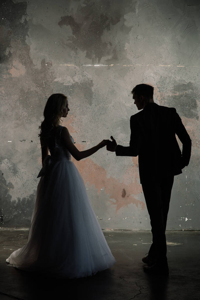 Art fashion studio photo of wedding couple silhouette groom and bride on colors background. - Фото, зображення