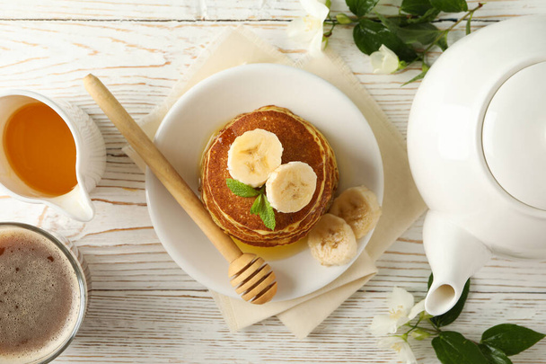 Composition with pancakes on white wooden background, top view. Sweet breakfast - Fotoğraf, Görsel