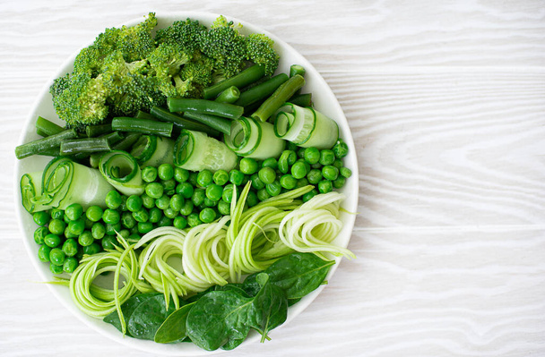 mix of fresh green vegetables on a plate - Фото, зображення