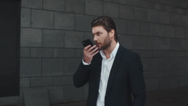 Business man talking on phone loudspeaker in city. Man recording voice message - Video, Çekim