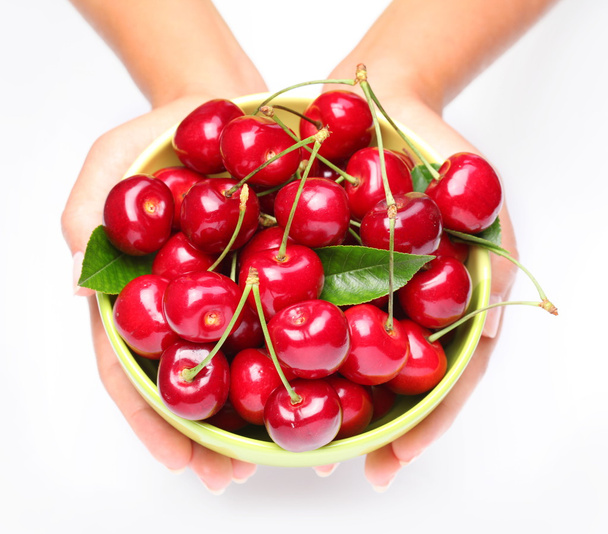 Crockery with cherries in woman hands. - Φωτογραφία, εικόνα