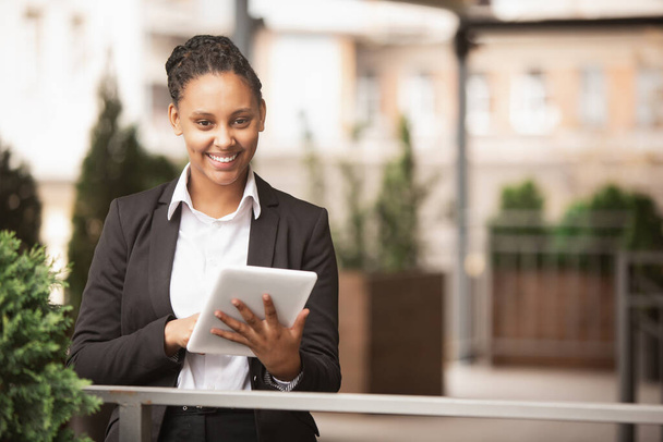 African-american businesswoman in office attire smiling, looks confident and happy, successful - Photo, image