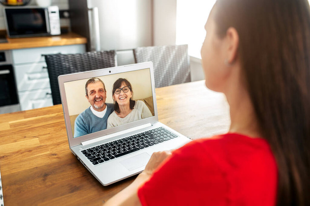 Video call. Woman talks online with her parents - Foto, imagen