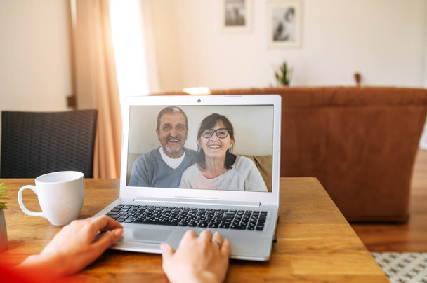 Video call. Woman talks online with her parents - 写真・画像