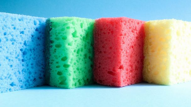 Many blue, red, yellow, green sponges are used to wash and wipe the dirt used by housewives in everyday life. They are made of porous material such as foam. good detergent retention. - Φωτογραφία, εικόνα